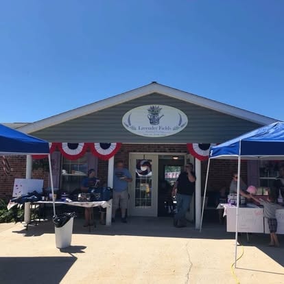 Residents and staff celebrating July 4th at Lavender Fields, decorated with patriotic red, white, and blue