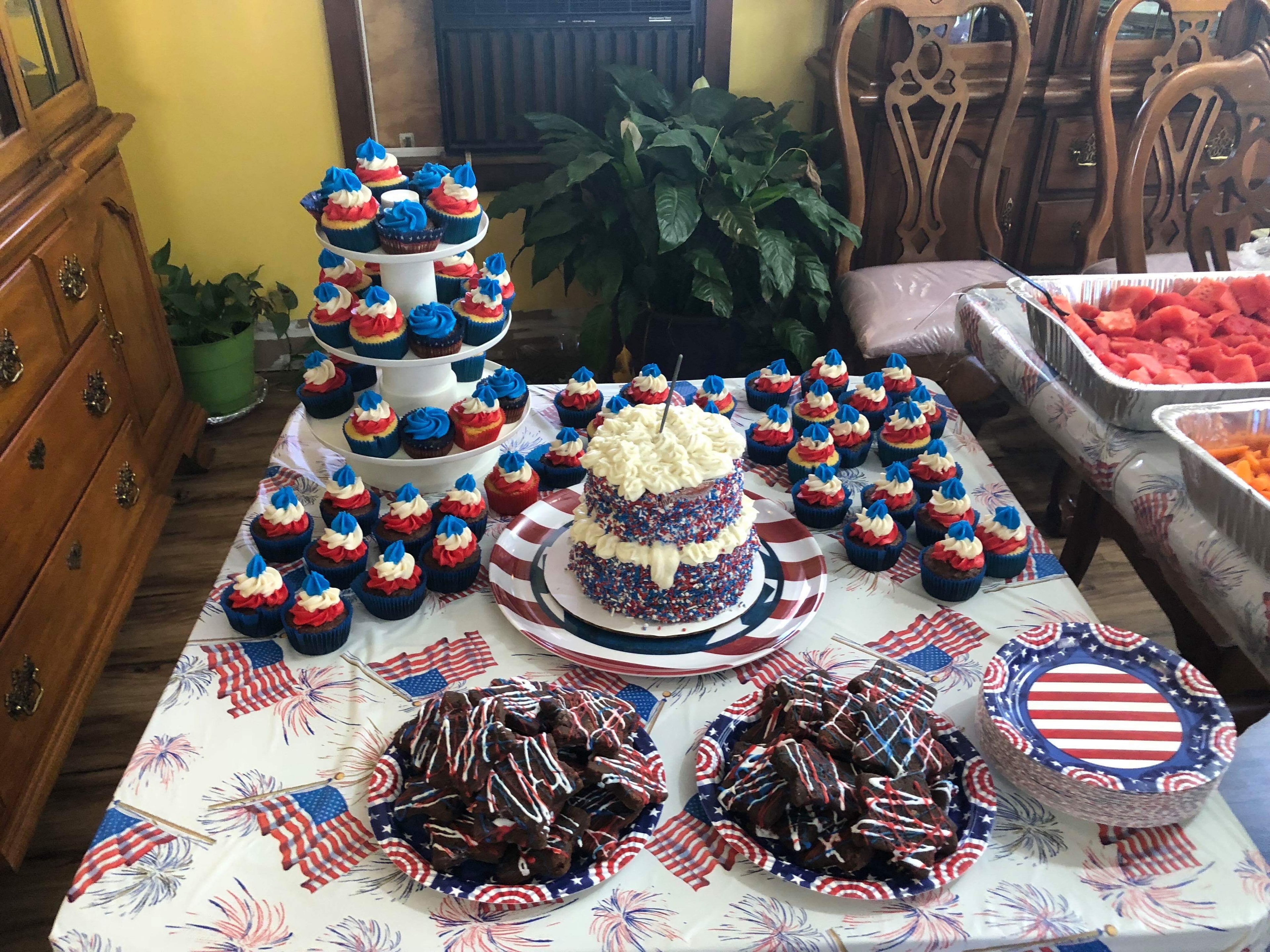 A table covered in red, white, and blue cupcakes, cake, brownies, and watermelon for a Fourth of July party at Lavender Fields